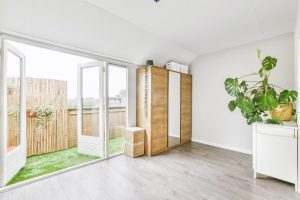 A converted garage space looking into a backyard.